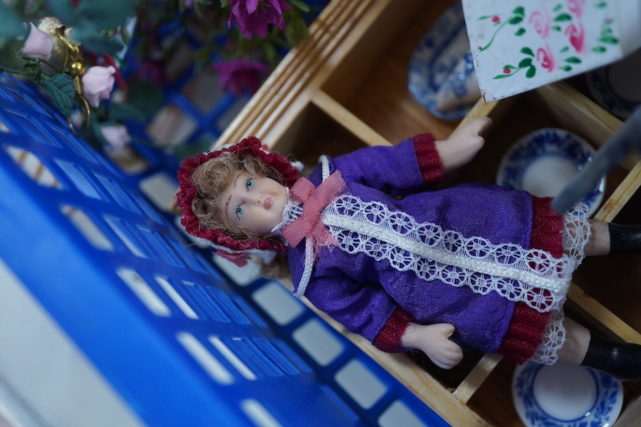 A modern doll’s house in the form of an oak framed Tudor house on three floors, with a shop on the ground floor, removable front panels on each floor and one side of the roof, with internal detailing and a good selection